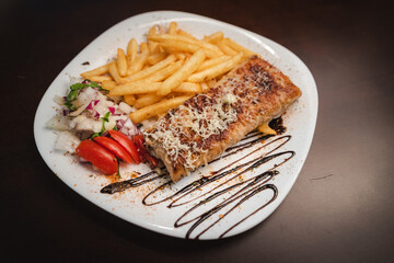 roast meat with cheese and salad on a plate and salad on a plate