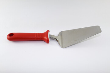 Spatula used to serve pizza with red handle