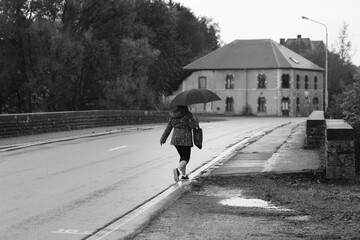 person walking on the street in the rain 