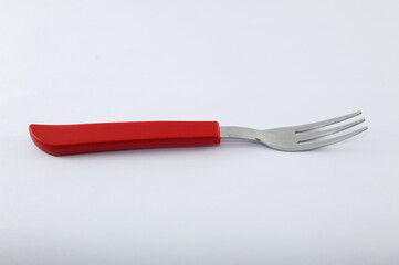 Fork with red handle and white background
