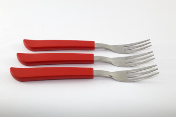Fork with red handle and white background
