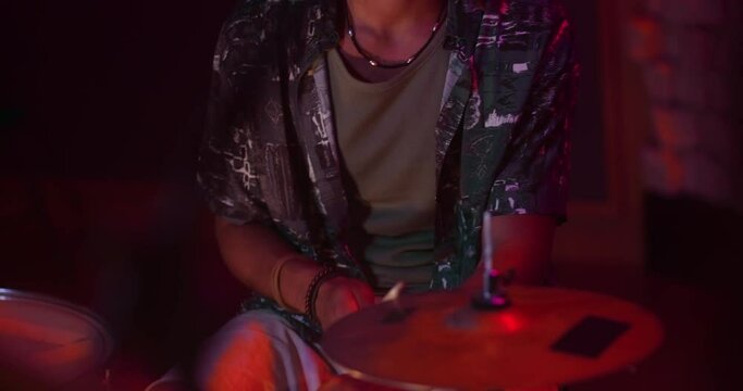 Man playing drums in music studio