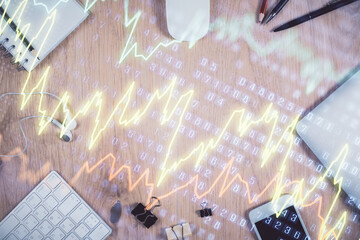 Multi exposure of forex graph hologram over desktop with phone. Top view. Mobile trade platform...