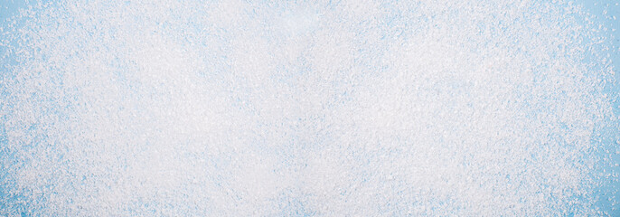 Christmas background texture, white snow on a blue background. Banner as a backdrop, an idea. View from above