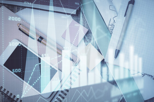 Multi exposure of forex graph hologram over desktop with phone. Top view. Mobile trade platform concept.