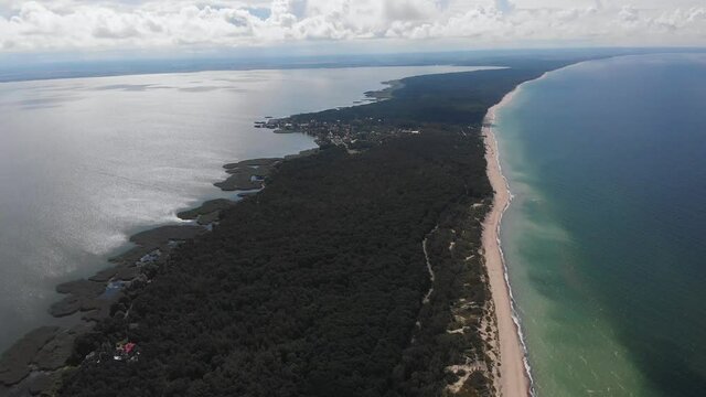 Beautiful aerial drone wide view of Curonian spit, Kurshskaya Kosa National Park, Curonian Lagoon and the Baltic Sea, Kaliningrad Oblast, Russia and Klaipeda County, Lithuania, summer day
