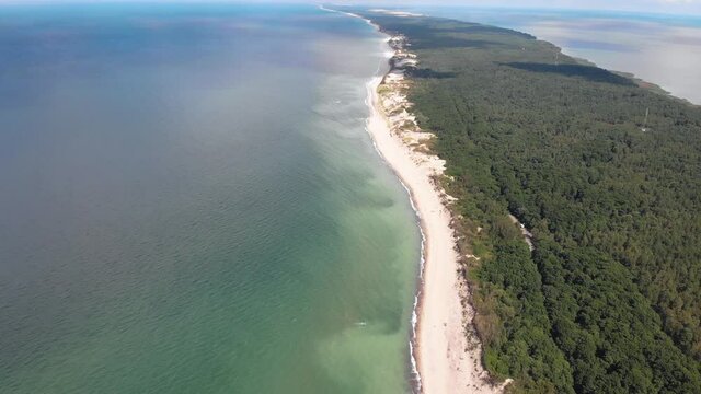 Beautiful aerial drone wide view of Curonian spit, Kurshskaya Kosa National Park, Curonian Lagoon and the Baltic Sea, Kaliningrad Oblast, Russia and Klaipeda County, Lithuania, summer day
