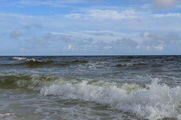 A wave from the ocean goes to the shore