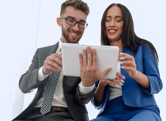 A confident manager discusses with a colleague a project pointin