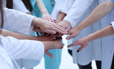 top view. a group of smiling doctors pointing at you.