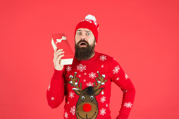 Winter holidays sale. happy new year. merry christmas. surprised bearded man in santa hat and sweater. brutal hipster celebrate xmas party. winter holiday preparations. present and gift shopping sale