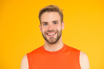 nice healthy smile. handsome young man with bristle. happy man with groomed hair. male beauty standard. guy casual style on yellow background. barbershop concept. sport and fitness fashion