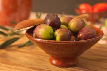 Jar full of olives and an olive twig