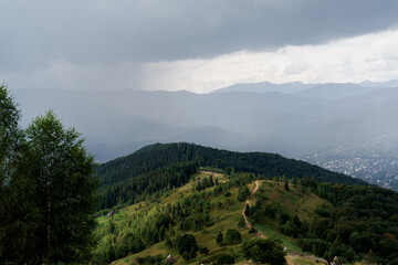 Obraz premium Rainfall in Karpathians mountains. Landscape of a beautiful countryside without people. Panoramic view in summer time. Advert for travel agency