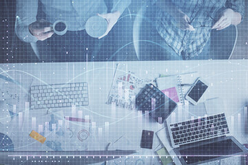 Double exposure of man and woman working together and financial chart hologram drawing. market analysis concept. Computer background. Top View.
