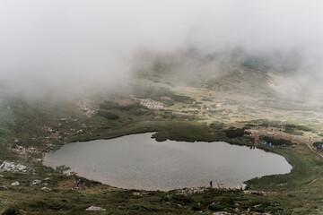 Mountain lake and in foggy day. Fog in Karpathian mountains. Tourism in Ukraine. Freedom and unity with nature