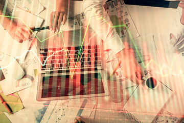 Double exposure of man and woman working together and financial graph hologram. Business concept. Computer background.