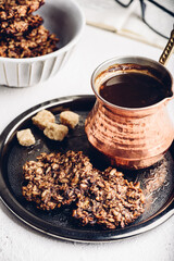 Banana oatmeal cookies with chocolate spread with turkish coffee on metal tray
