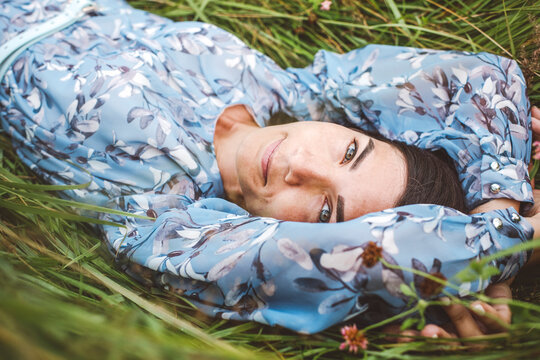 High angle view of young woman lying in field