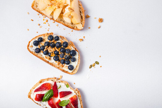 Studio shot of three slices of bread with fresh fruits