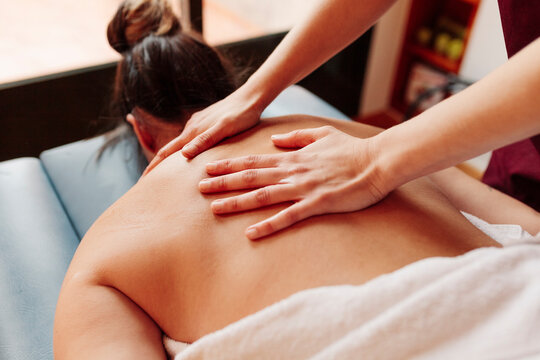 Woman Having Back Massage While Lying On Stretcher