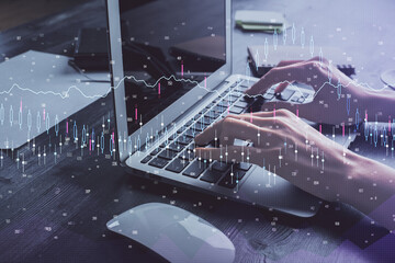 Double exposure of woman hands typing on computer and forex chart hologram drawing. Stock market invest concept.