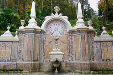 Obraz premium Tiled decorated water fountain with trees on background in Sintra, Portugal. World Heritage Site by Unesco