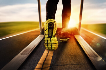 Man run with treadmill made of asphalt during sunrise. Concept of running outdoor
