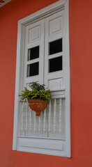 Balconies and windows in red, blue, green, yellow, with gardens and flowers, in the coffee region in Colombia