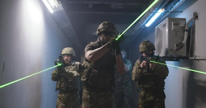 SWAT team with commander walking in dark corridor