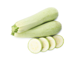 Cut and whole green ripe zucchinis on white background, top view