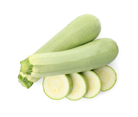 Cut and whole green ripe zucchinis on white background, top view