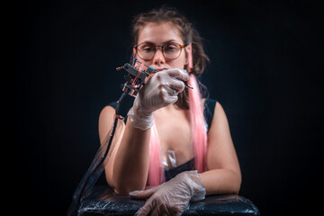 Tattoo artist with a tattoo-machine in tatoo salon