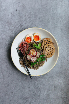 Soba noodle with lotus root, ramen egg, pickled onions and radish