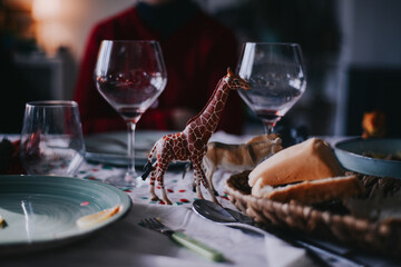 A beautiful christmas tablecloth with a toy giraffe