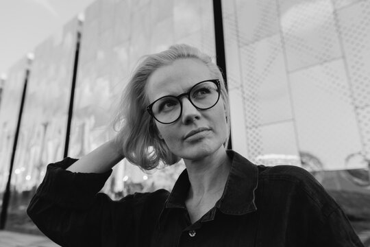 Woman at steel mirror wall