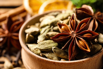 Dry anise star and cardamon seeds in bowl, closeup. Mulled wine ingredients