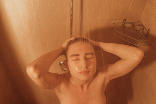 Young woman taking hot shower