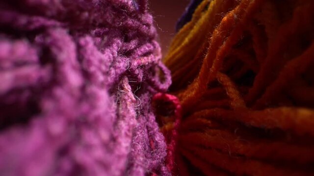 Macro dolly shot a sliding footage of a beautiful colored wool yarn texture. May be used for background. Laowa probe lens.