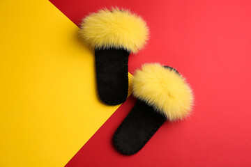 Pair of soft slippers on color background, flat lay