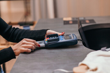 Woman paying with credit card in shop