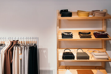 Collection of bags and clothes in fashion boutique