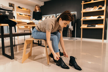 Woman trying on boots in store