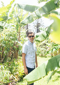 Smiling australian male standing in banana field