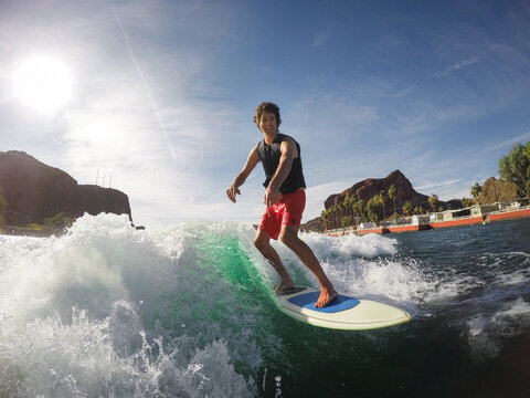 Man Wakesurfing on Desert River