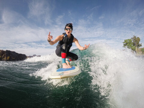 Woman Waksurfing on Desert River