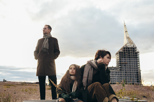 Woman, child and man on wasteland