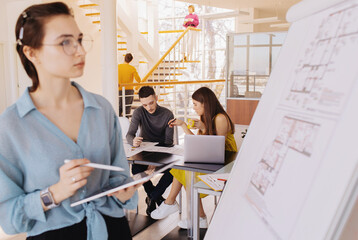 Young woman examining construction draft