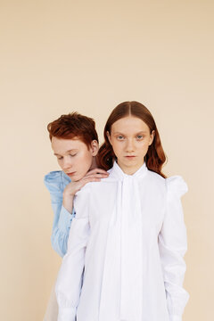 Androgynous couple in retro blouses