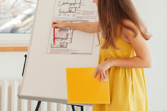 Anonymous architect showing blueprints during conference